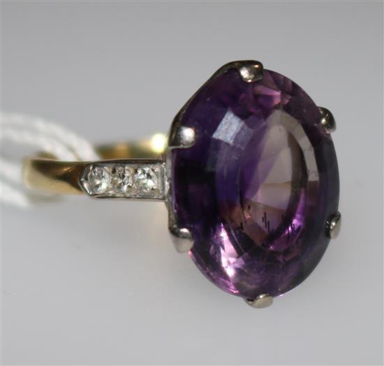 An 18ct gold and amethyst dress ring with diamond set shoulders, size K.